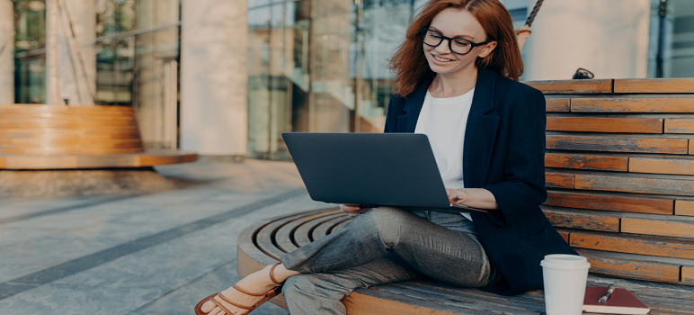 woman-with-a-laptop-reading-articles-on-self-improvement